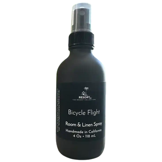 Black room and linen spray bottle labeled 'Bicycle Flight' on a white background
