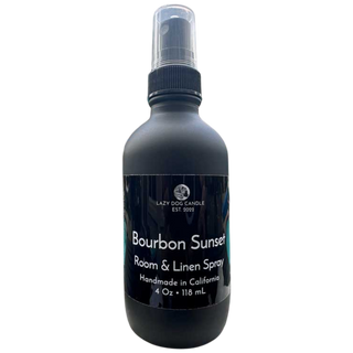 Black room and linen spray bottle labeled 'Bourbon Sunset' on a white background