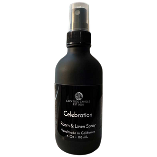 Black room and linen spray bottle labeled 'Celebration' by Lazy Dog Candle on a white background