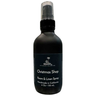 Black room and linen spray bottle labeled 'Christmas Shop' on a white background