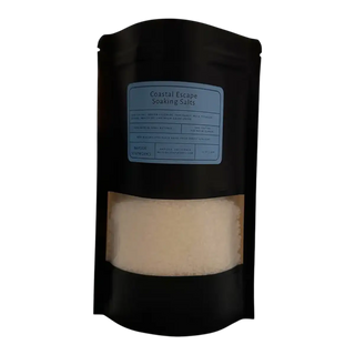Black packaging of 'Coastal Escape Soaking Salts' with a label on a white background