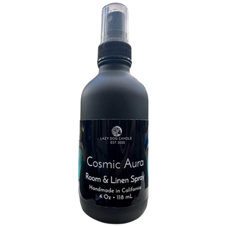 Black room and linen spray bottle labeled 'Cosmic Aura' on a white background