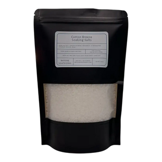 Black packaging of Cotton Breeze Soaking Salts with a label on a white background