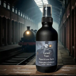Bottle of 'Cursed Train' room and linen spray with a haunted train in the background