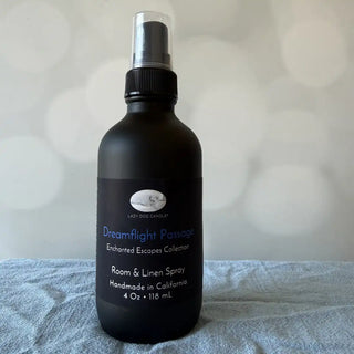 Black room & linen spray bottle labeled 'Dreamflight Passages' on a light gray background