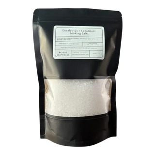 Black packaging of Eucalyptus + Spearmint Soaking Salts with a clear window showing the product inside.