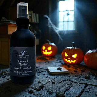 Room spray bottle labeled 'Haunted Garden' with Halloween pumpkins in the background