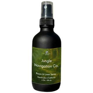 Black spray bottle with green label featuring 'Jungle Navigation Co.' on a white background