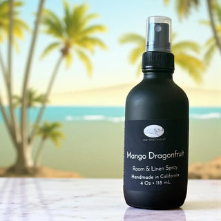 Black room & linen spray bottle with palm trees and beach in the background