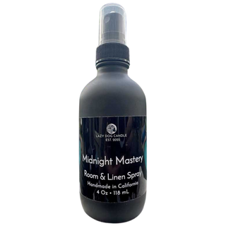 Black room and linen spray bottle labeled 'Midnight Mastery' by Lazy Dog Candle on a white background.