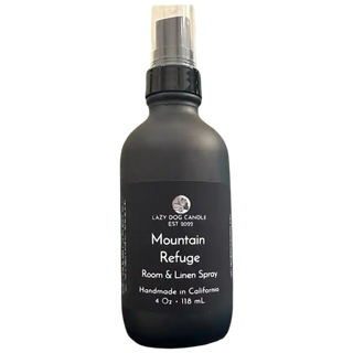 Black room spray bottle labeled 'Mountain Refuge' by Lazy Dog Candle on a white background