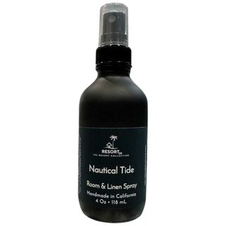 Black room and linen spray bottle labeled 'Nautical Tide' on a white background
