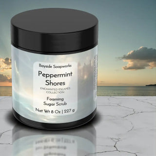 Jar of Bayside Soapworks Peppermint Shores Foaming Sugar Scrub with a scenic background
